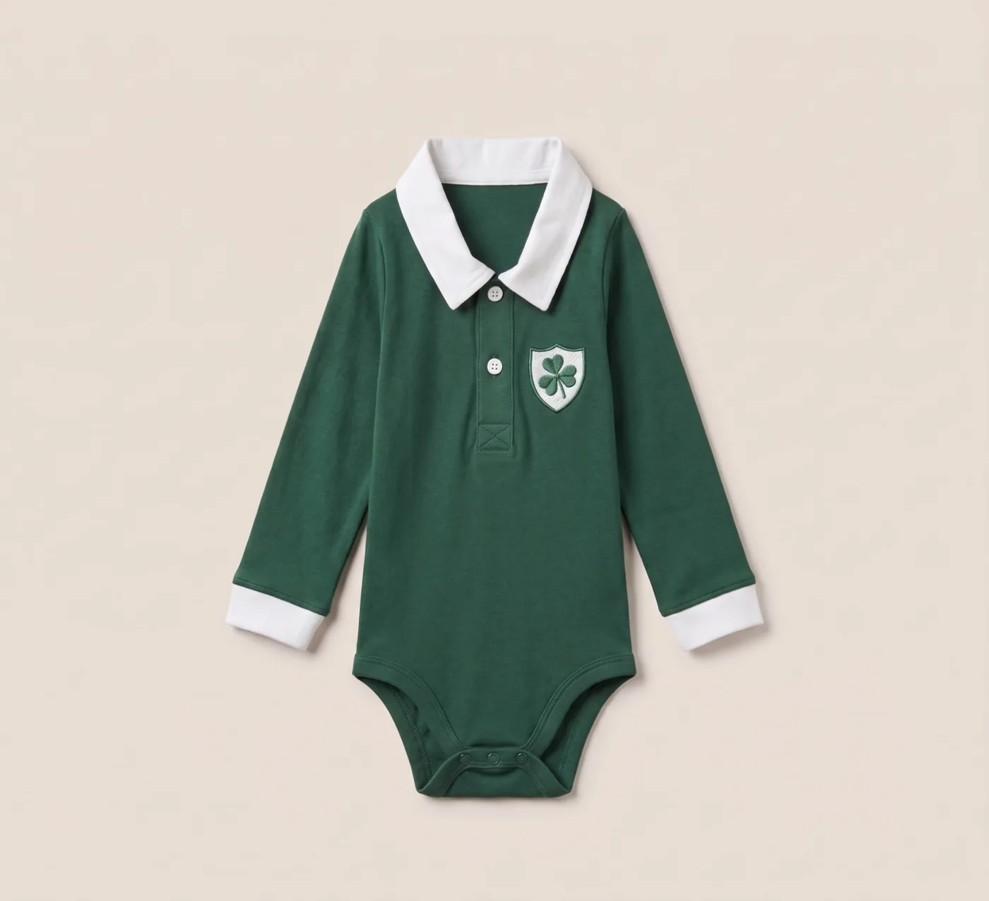 Ireland baby rugby romper in deep green with a white collar and clover crest